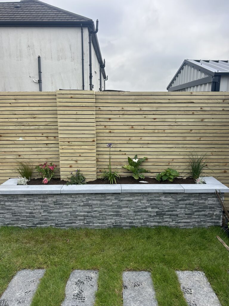 Raised bed with porcelain wall cladding finished with natural limestone capping